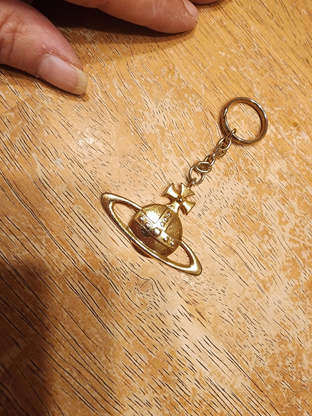 gold-tone Vivienne Westwood Orb keychain featuring the brand's iconic Saturn